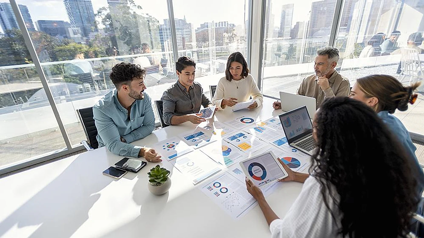 Business team analyzing market research data and developing strategic recommendations